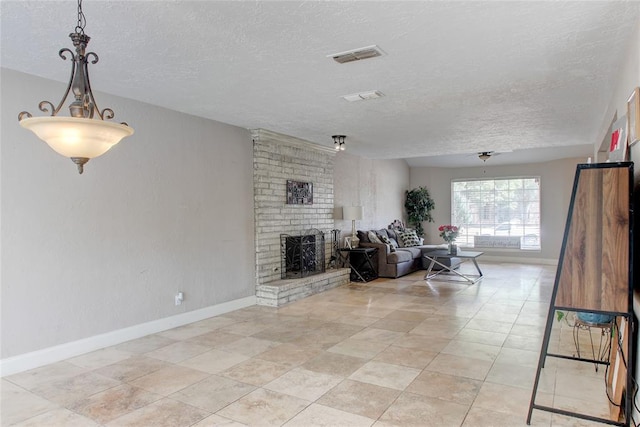 living room featuring a fireplace and a textured ceiling