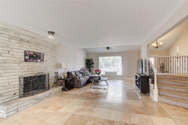 tiled living room featuring a textured ceiling, ceiling fan with notable chandelier, lofted ceiling, and a brick fireplace