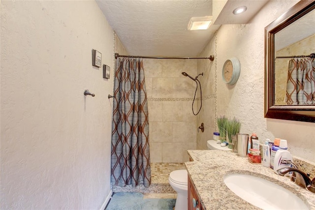 bathroom featuring walk in shower, vanity, a textured ceiling, and toilet