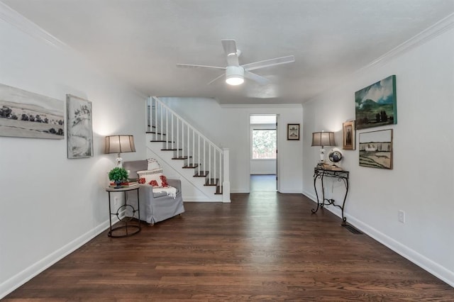 entryway with ceiling fan, crown molding, and dark wood-type flooring