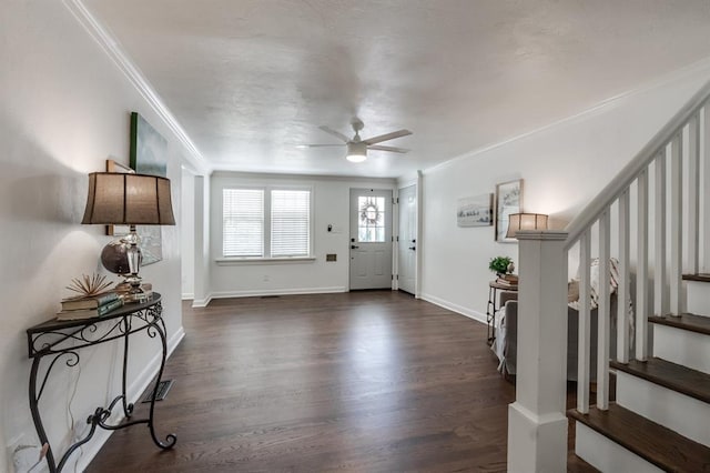 foyer with ceiling fan, crown molding, and dark wood-type flooring