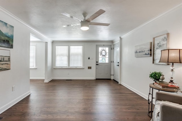 entrance foyer featuring ceiling fan, crown molding, and dark wood-type flooring