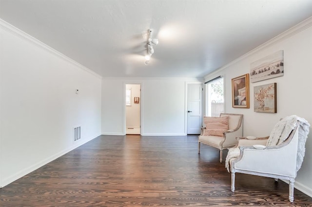 sitting room featuring dark hardwood / wood-style floors and crown molding