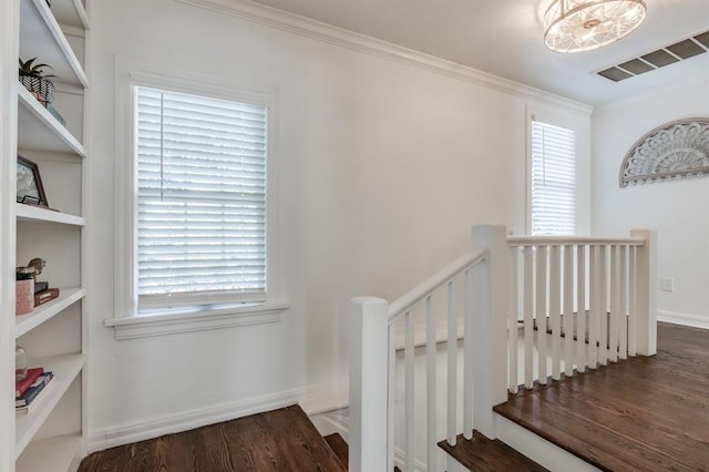 stairway featuring hardwood / wood-style floors and ornamental molding