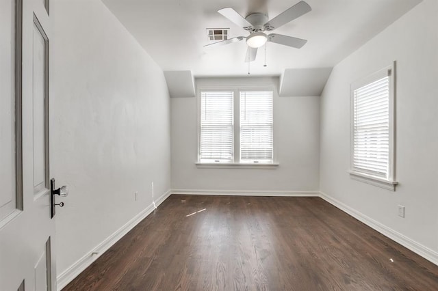 unfurnished room with ceiling fan, dark wood-type flooring, a healthy amount of sunlight, and vaulted ceiling