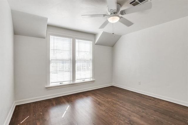 additional living space with a wealth of natural light, dark wood-type flooring, and ceiling fan