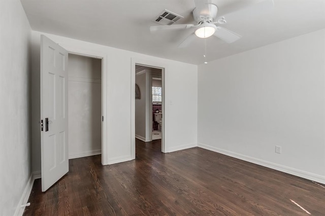 unfurnished bedroom featuring ceiling fan and dark hardwood / wood-style floors