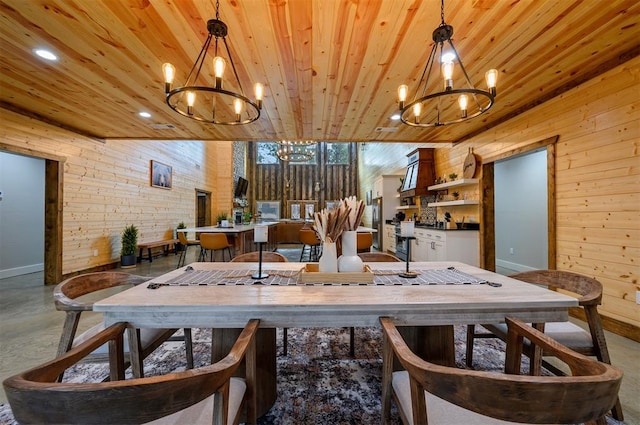 dining area featuring wood walls, wooden ceiling, and an inviting chandelier