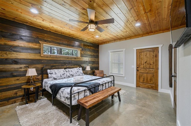 bedroom with concrete flooring, ceiling fan, wooden walls, and wood ceiling