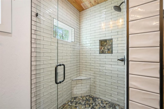 bathroom with an enclosed shower and wooden ceiling