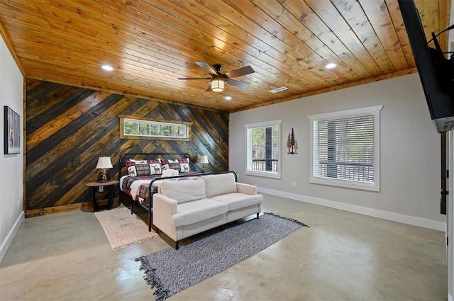 bedroom featuring ceiling fan, wooden ceiling, wooden walls, and concrete floors