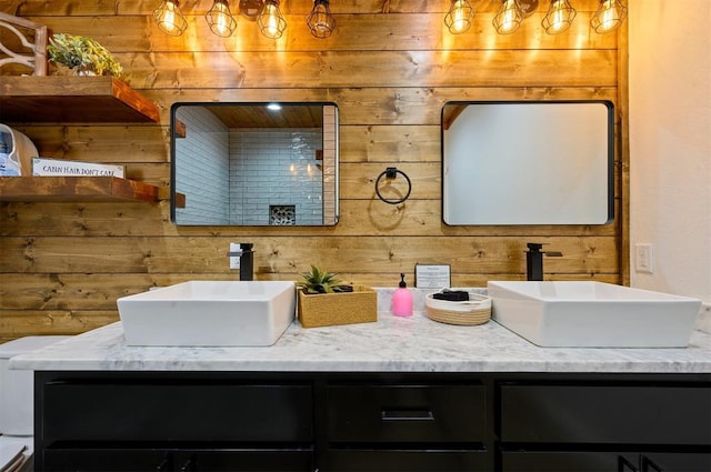 bathroom featuring vanity and wooden walls