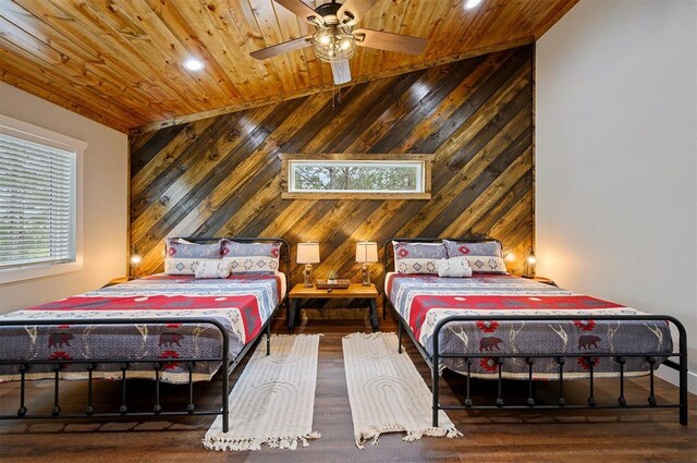 bedroom featuring wood ceiling, ceiling fan, wood-type flooring, and wooden walls