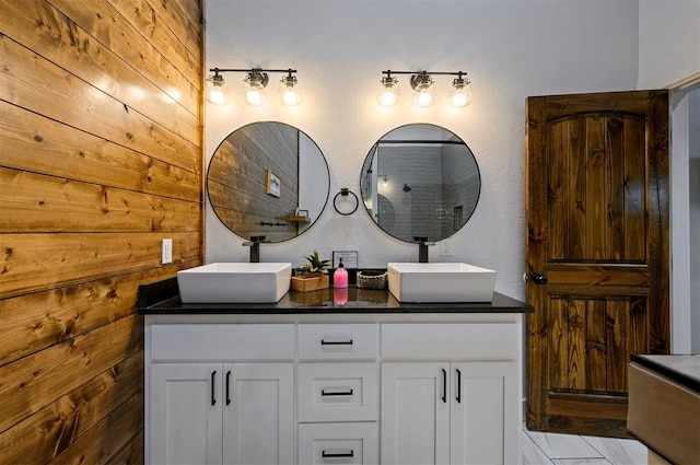 bathroom featuring wooden walls and vanity