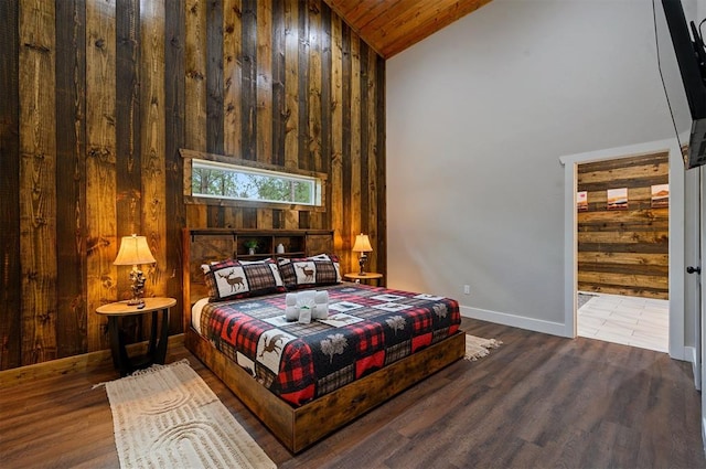 bedroom with hardwood / wood-style flooring, high vaulted ceiling, wooden ceiling, and wooden walls