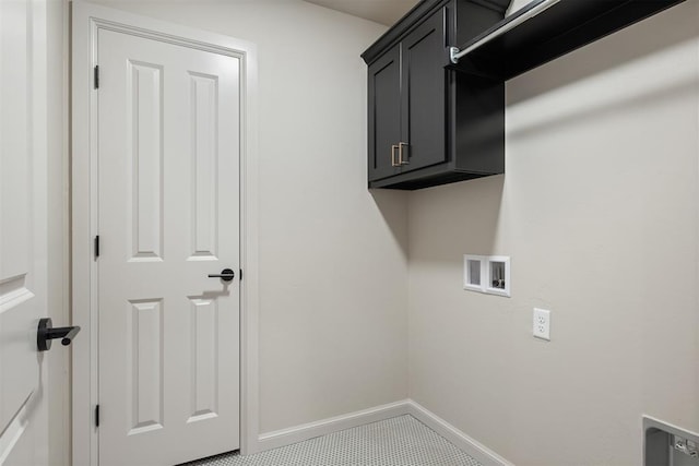 clothes washing area featuring washer hookup, cabinets, and tile patterned floors