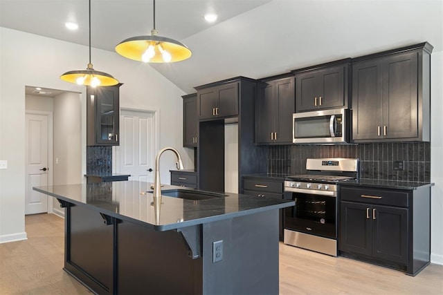 kitchen with decorative backsplash, stainless steel appliances, sink, hanging light fixtures, and lofted ceiling