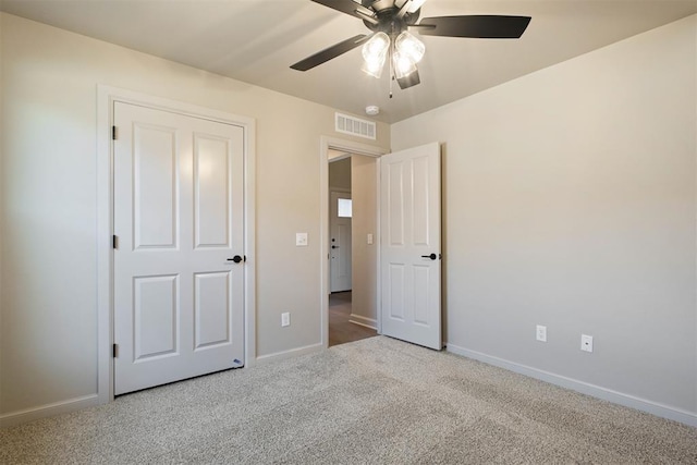 unfurnished bedroom with ceiling fan and light colored carpet