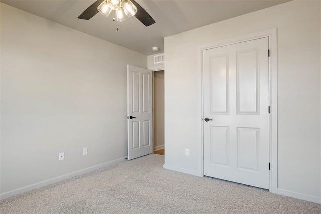 unfurnished bedroom featuring a closet, light colored carpet, and ceiling fan