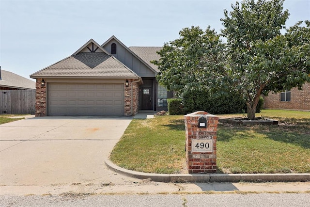 view of front of home with a front yard and a garage