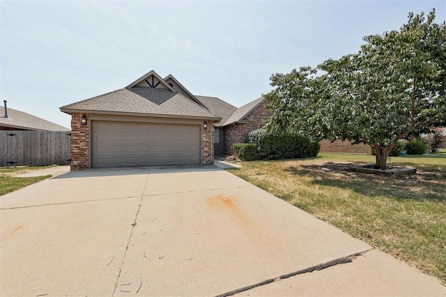 view of front of home featuring a front yard and a garage