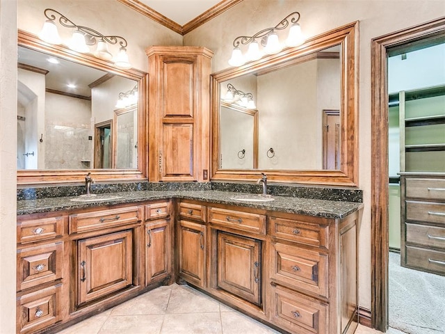 full bath featuring double vanity, tile patterned flooring, ornamental molding, and a sink