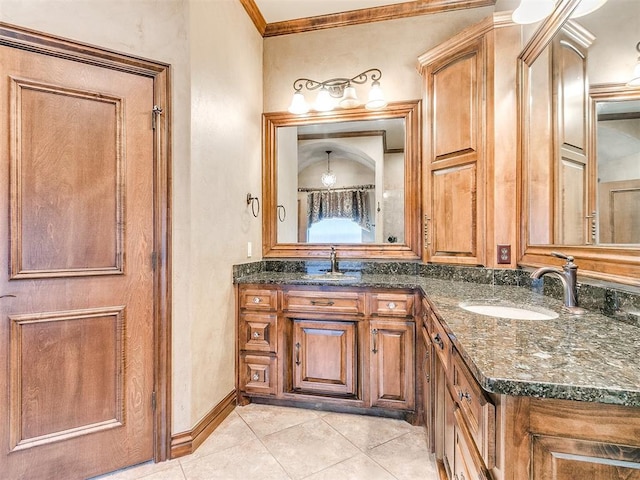 bathroom with tile patterned floors, ornamental molding, double vanity, and a sink