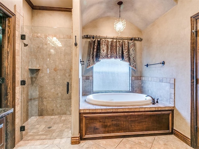 bathroom with tile patterned flooring, a shower stall, a bath, and lofted ceiling