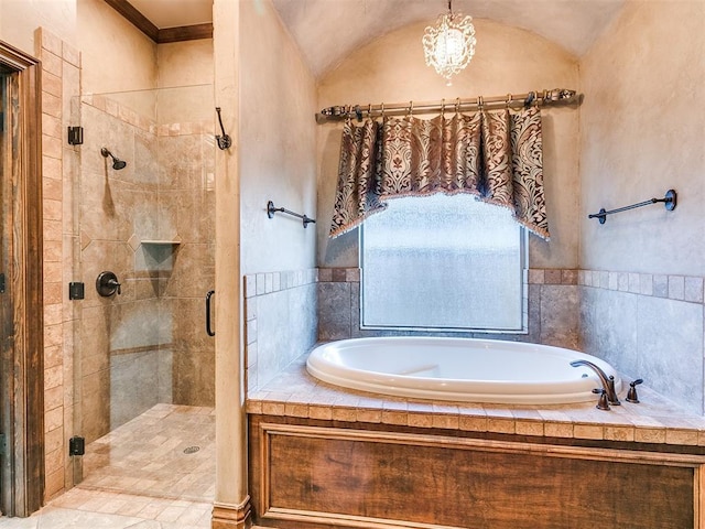 full bath with a shower stall, a bath, and vaulted ceiling