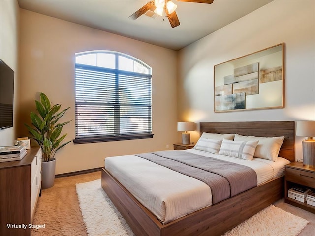 bedroom with light colored carpet and ceiling fan