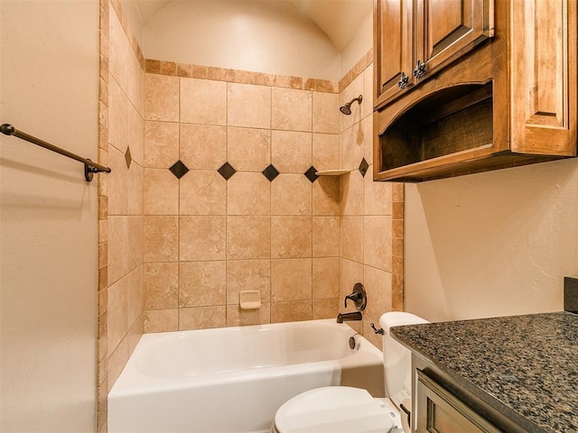 bathroom featuring toilet, vanity, bathtub / shower combination, and vaulted ceiling