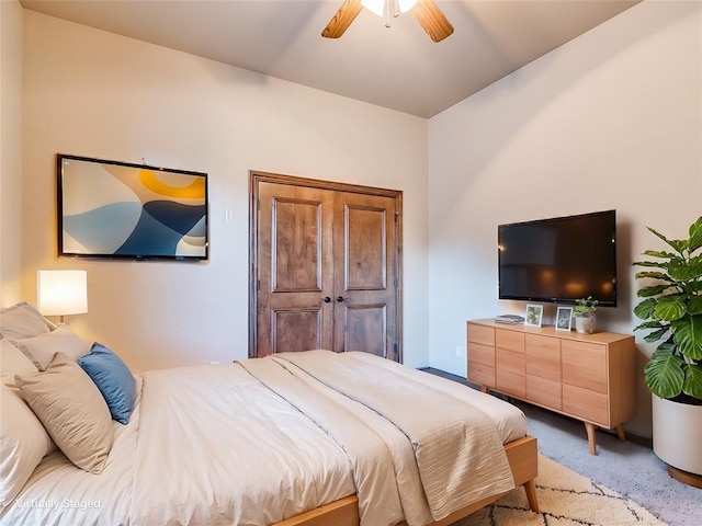 bedroom featuring light colored carpet and ceiling fan