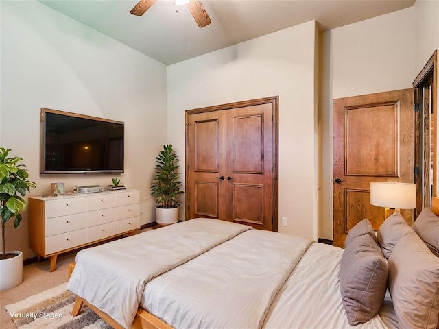 bedroom featuring light colored carpet and ceiling fan