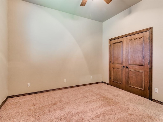 unfurnished bedroom featuring carpet flooring, a ceiling fan, and baseboards