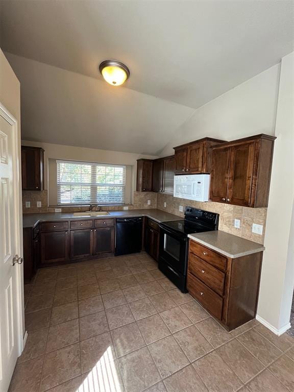 kitchen with black appliances, tasteful backsplash, dark brown cabinetry, and vaulted ceiling