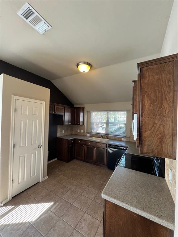 kitchen with dark brown cabinetry, tasteful backsplash, vaulted ceiling, light tile patterned flooring, and black appliances