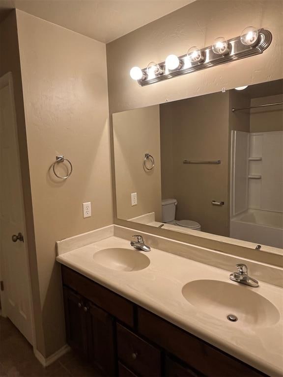 bathroom with vanity, toilet, and walk in shower