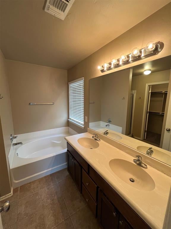 bathroom featuring vanity and separate shower and tub