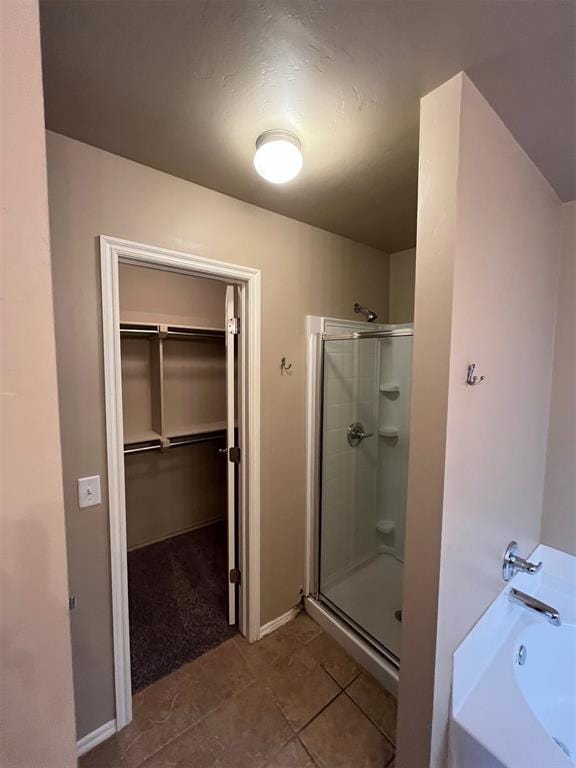 bathroom featuring tile patterned flooring and independent shower and bath