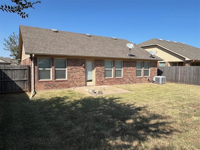 back of property with a patio area, a yard, and central AC unit