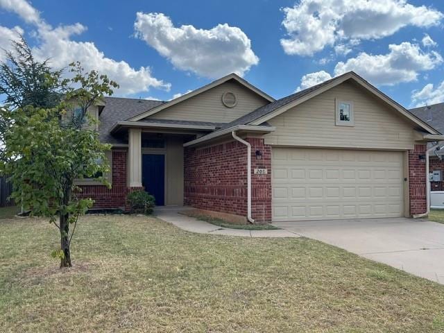 view of front of property with a garage and a front lawn