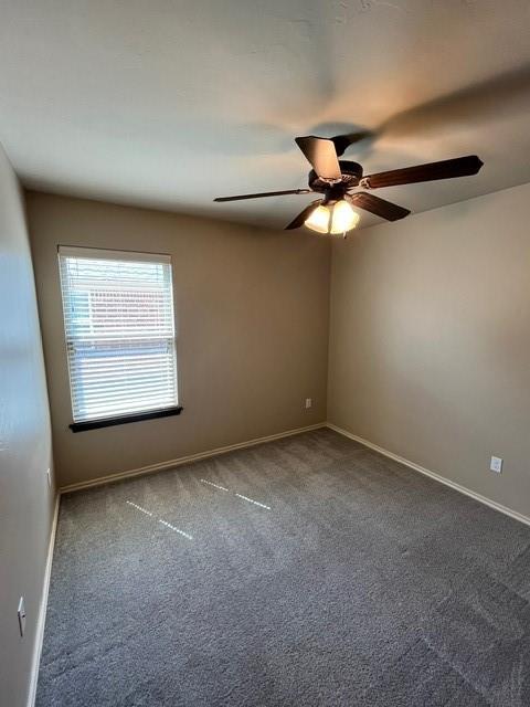 spare room with carpet floors and ceiling fan