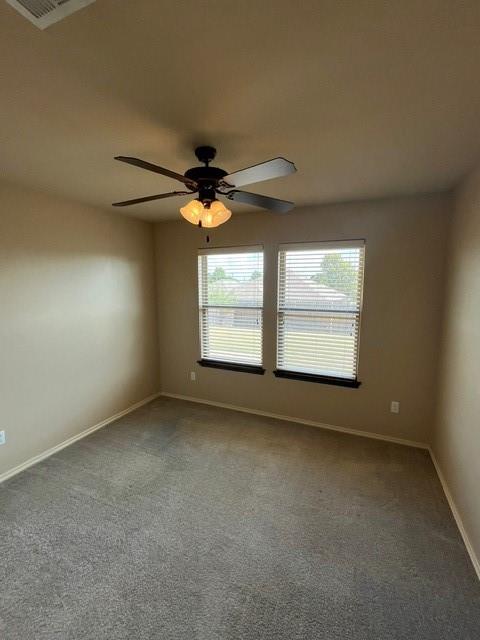 unfurnished room featuring ceiling fan and carpet floors