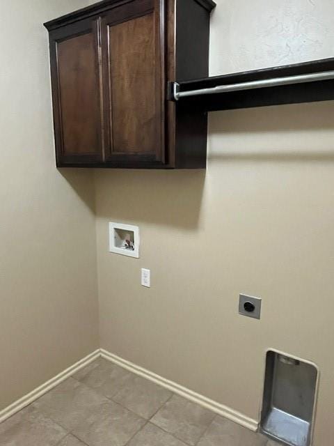 laundry room with washer hookup, electric dryer hookup, cabinets, and light tile patterned floors