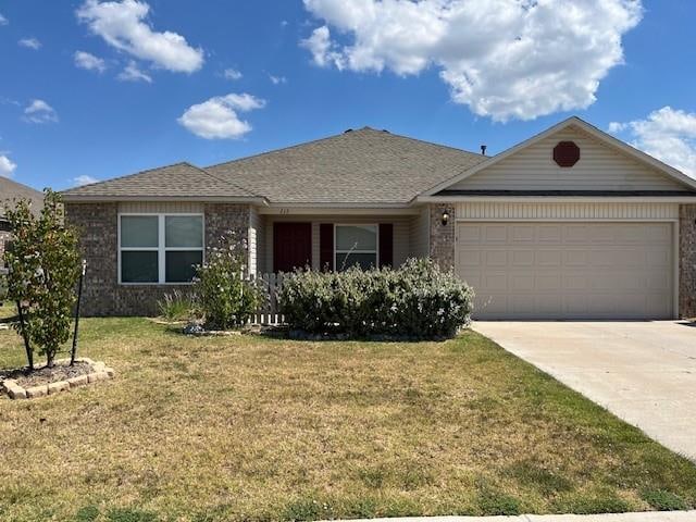 single story home with a front yard and a garage