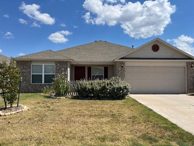 ranch-style house featuring a front lawn and a garage