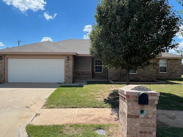 view of front of property with a front yard and a garage