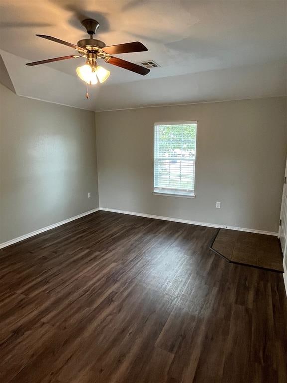 spare room featuring ceiling fan and dark wood-type flooring