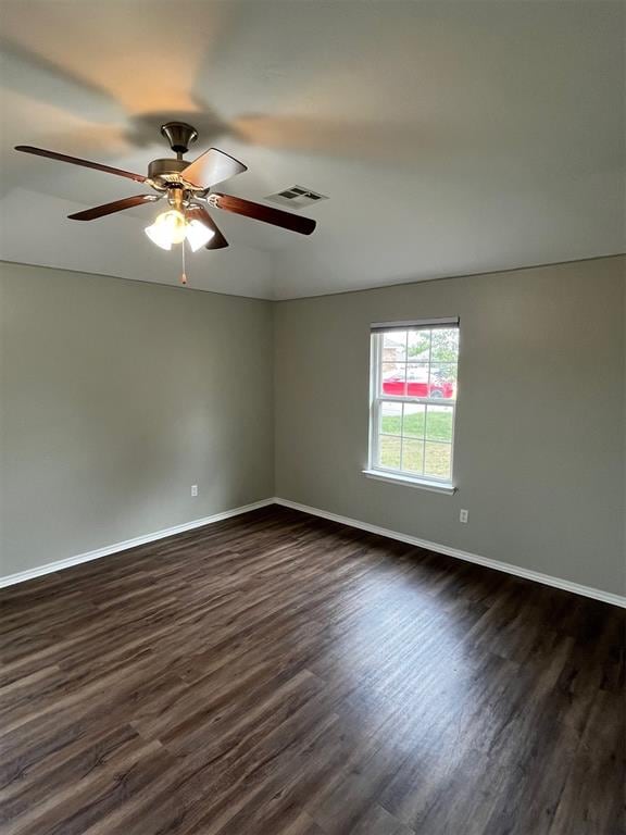 empty room featuring ceiling fan and dark wood-type flooring