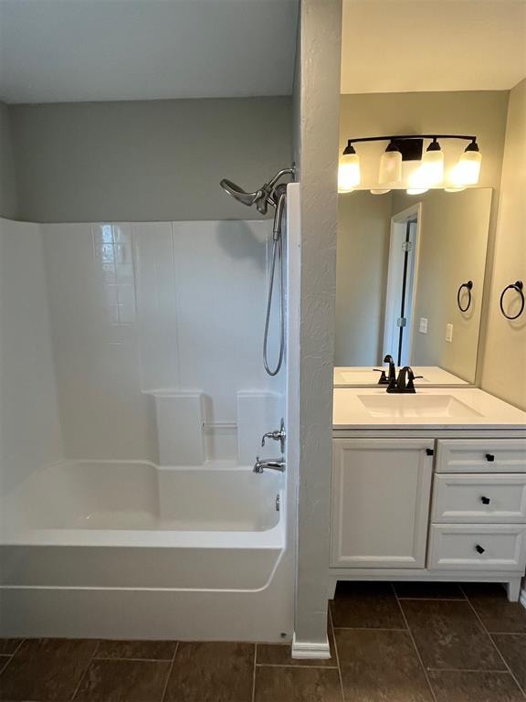 bathroom with bathing tub / shower combination, tile patterned flooring, and vanity